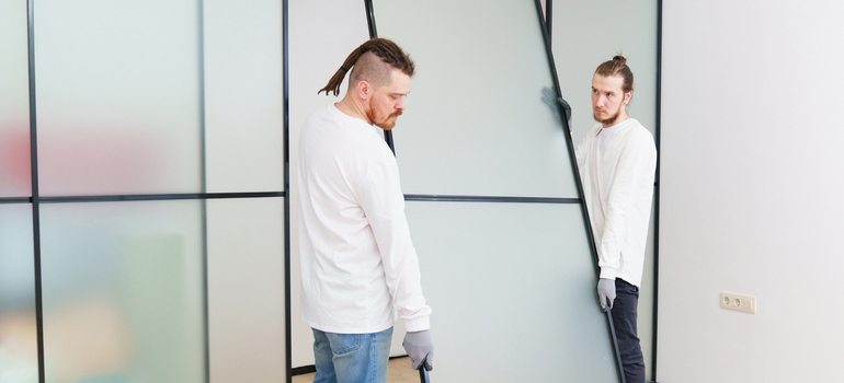 professional technicians working on office glass partition